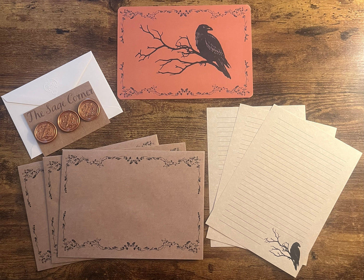 Autumn Letter Writing Set flat lay with raven stationery, kraft envelopes, lined writing sheets, and copper wax seals.
