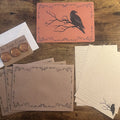 Letter Writing Set — Autumn 2026, square flat lay with raven correspondence card, lined writing paper, decorated envelopes, copper wax seals, and pen.