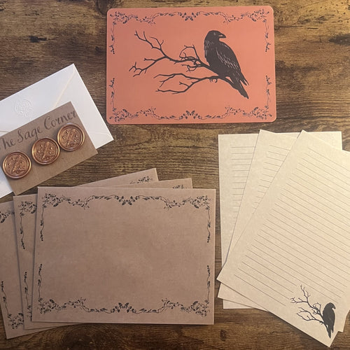 Letter Writing Set — Autumn 2026, square flat lay with raven correspondence card, lined writing paper, decorated envelopes, copper wax seals, and pen.