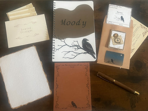 Autumn 2026 Writer’s Corner Collection flat lay with raven notebook, journal prompts, archive specimen card, writing paper, pen, and seasonal stationery.