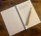 Inside the Autumn Seasonal Notebook, open to lined pages with sample handwritten reflection and a pen.